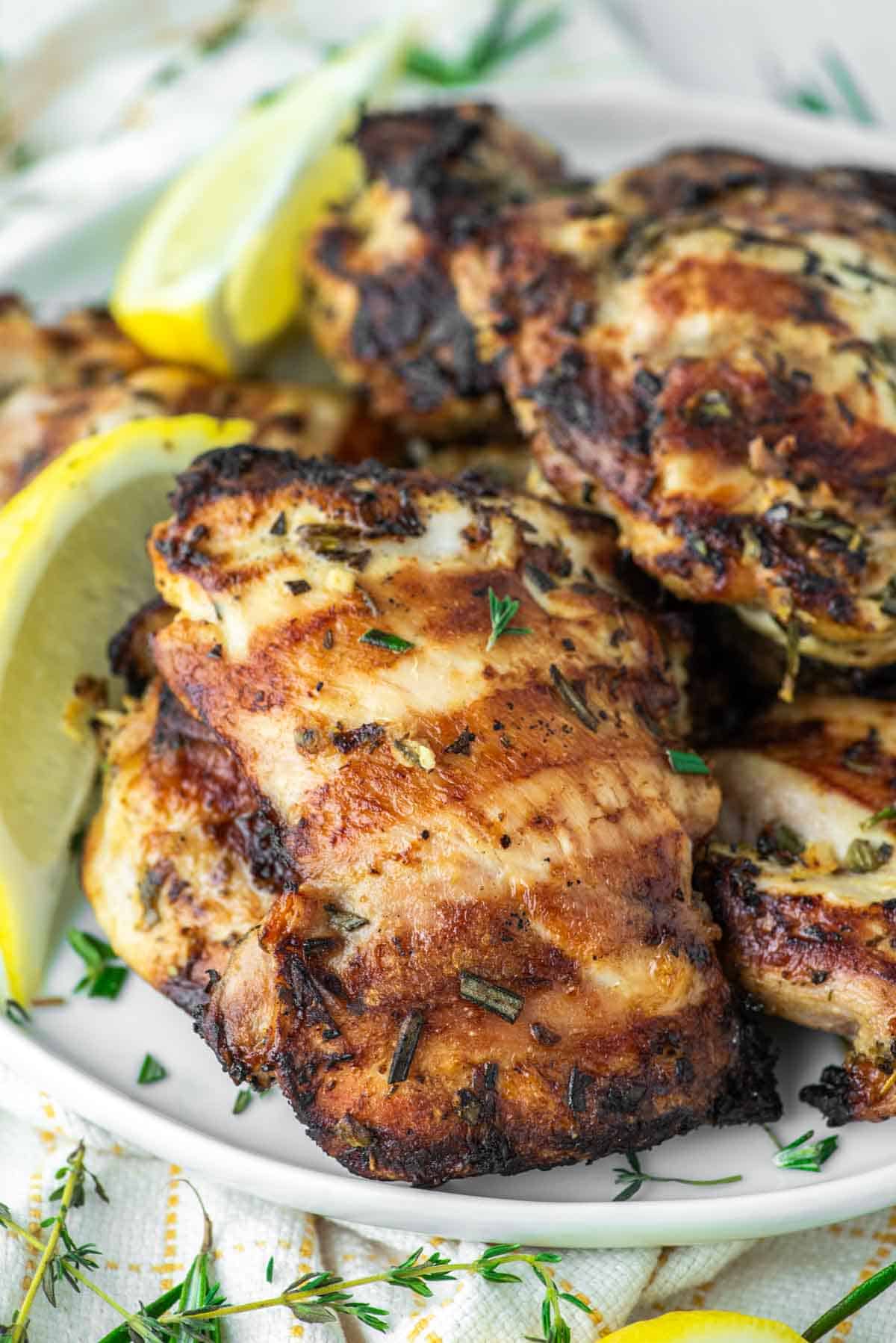close-up of grilled lemon herb chicken on plate