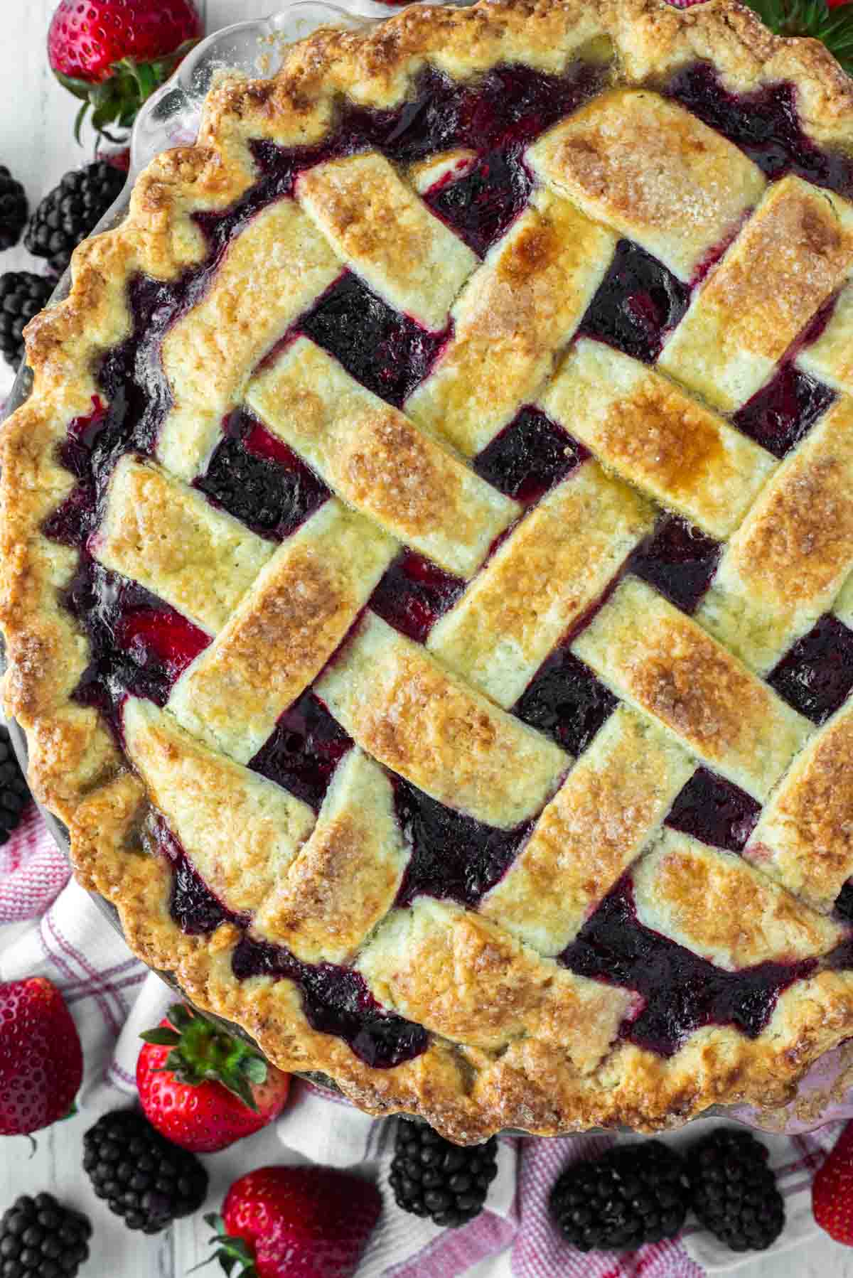 overhead shot of strawberry blackberry pie on kitchen towel